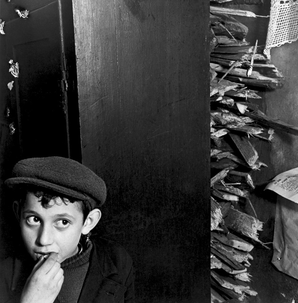 Roman Vishniac (Russian-American, 1897-1990) 'Boy with kindling in a basement dwelling, Krochmalna Street, Warsaw' c. 1935-1938
