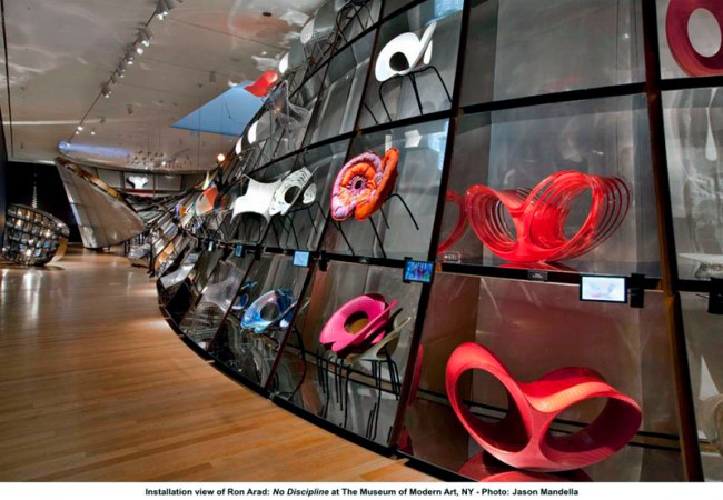 Installation view of 'Ron Arad: No Discipline' exhibition, featuring 'Cage sans Frontières (Cage without Borders)' with in the foreground, 'Oh Void 2' armchairs