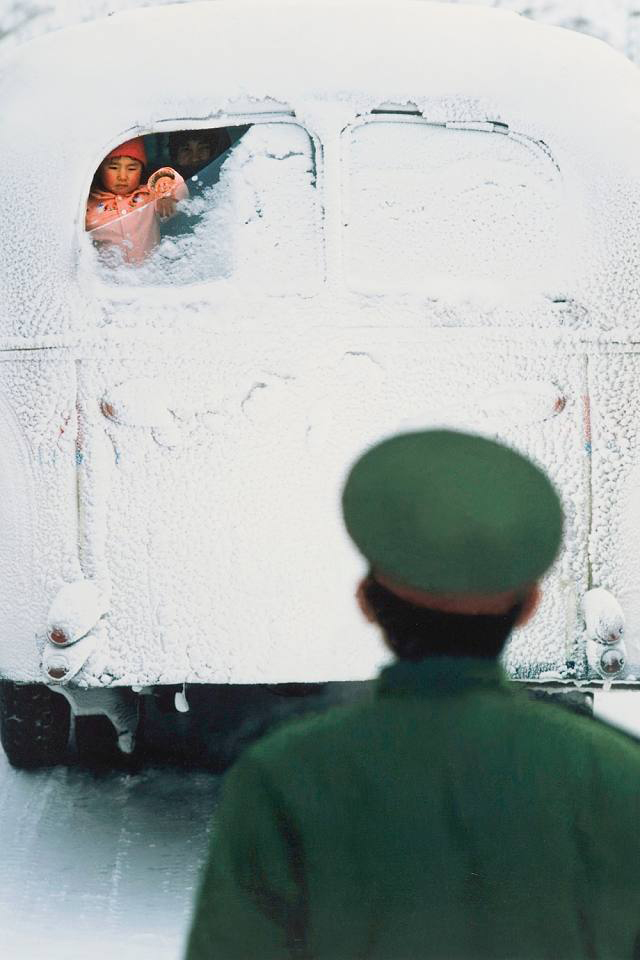 Feng Jianxin. 'A soldier bids farewell to his wife and child who have just visited him and are now returning home' Weichang, Hebei, Winter 1987 from the exhibition 'Humanism in China: A Contemporary Record of Photography' at the China Institute in America, New York, Sept - Dec, 2009