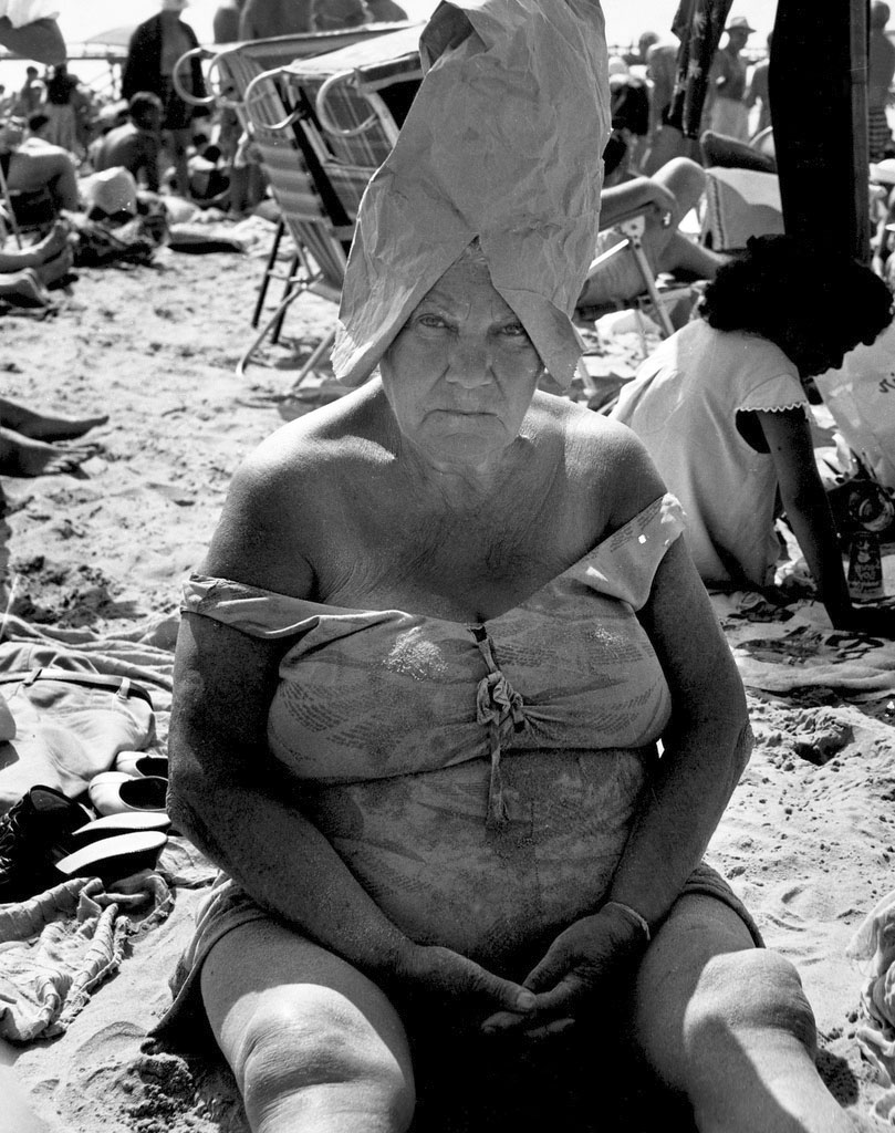 Leon Levinstein (American, 1910-1988) 'Untitled [Beach Scene: Woman Wearing Paper Bag Hat, Coney Island, New York]' 1950s