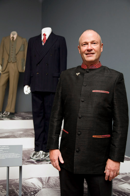 Dr Marcus Bunyan at the opening of Manstyle in front of a two-piece c. 1949 Simpsons of Picadilly, London blue pin-stripped suit and 1940's tie from his collection