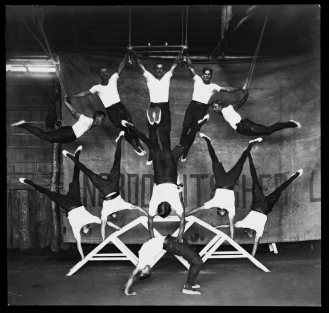 Paul Dubotzki (German, 1891-1969) 'Internees perform a breathtaking acrobatic number in the Holsworthy gym' c. 1918
