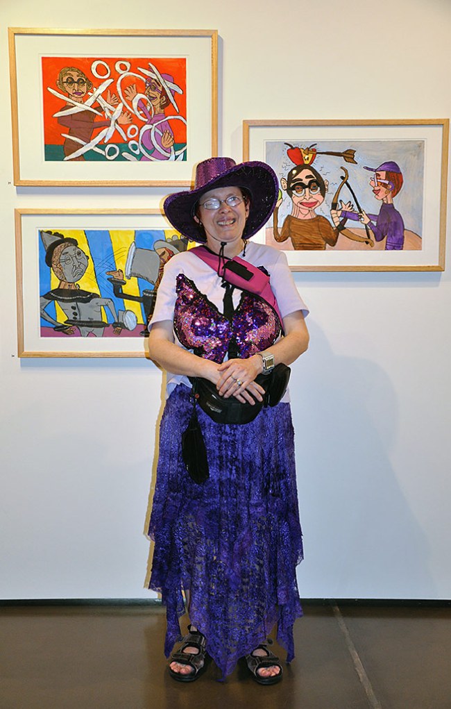 Artist Catherine Staughton standing in front of her work