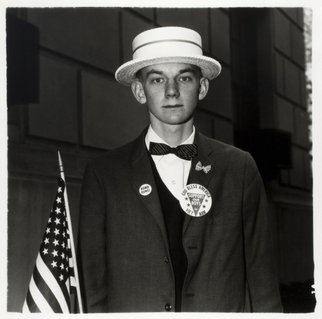 Diane Arbus. 'Boy with a straw hat waiting to march in a pro-war parade, N.Y.C. 1967' 1967
