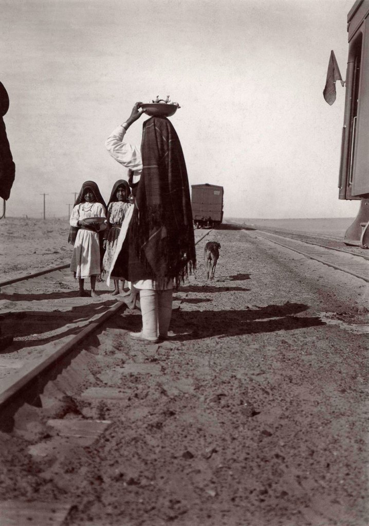 George Wharton James (American, 1858-1923) 'Selling goods along tracks' late 1880s to early 1900s from the exhibition Exhibition: 'Time Exposures: Picturing a History of Isleta Pueblo in the 19th Century' at the National Museum of the American Indian, New York, September 2011 - June 2012