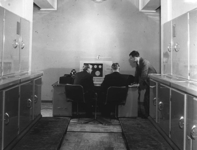 Alan Turing with two colleagues at the Ferranti Mark I computer