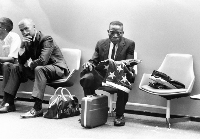 Harry Benson (Scottish, b. 1929) 'Grieving man, holding flag' 1971