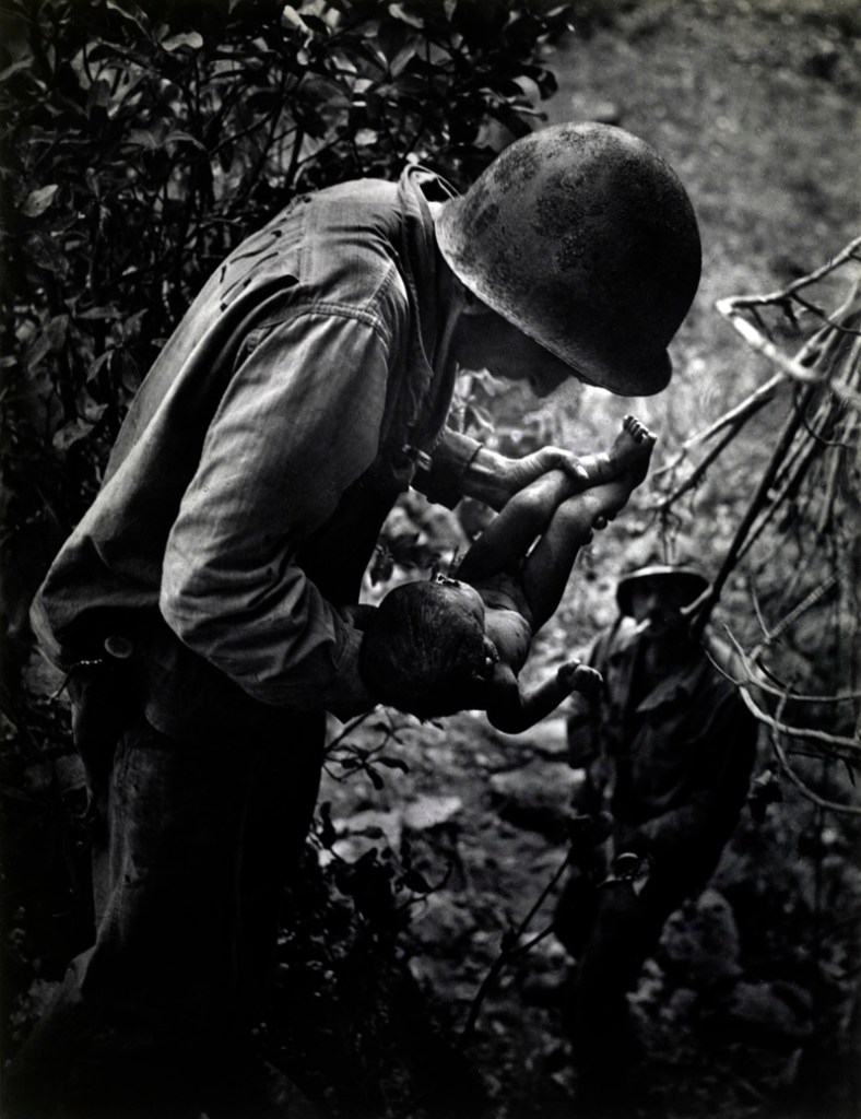 W. Eugene Smith (American, 1918-1978) 'Wounded, dying infant found by American soldier in Saipan Mountains' June 1944