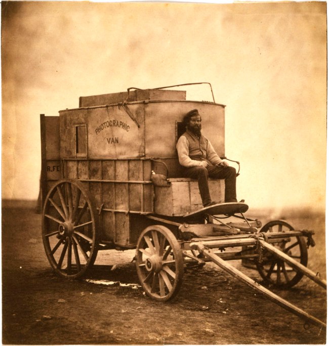 Roger Fenton (English, 1819-1869) 'The artist's van [Marcus Sparling, full-length portrait, seated on Roger Fenton's photographic van]' 1855