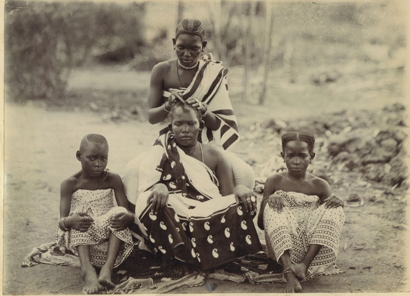 Unidentified photographer. 'Dressing hair. Women of the E. Coast. Africa' Tanzania, early twentieth century