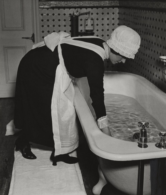 Bill Brandt (British born Germany, 1904-1983) 'Parlourmaid Preparing a Bath before Dinner' c. 1936