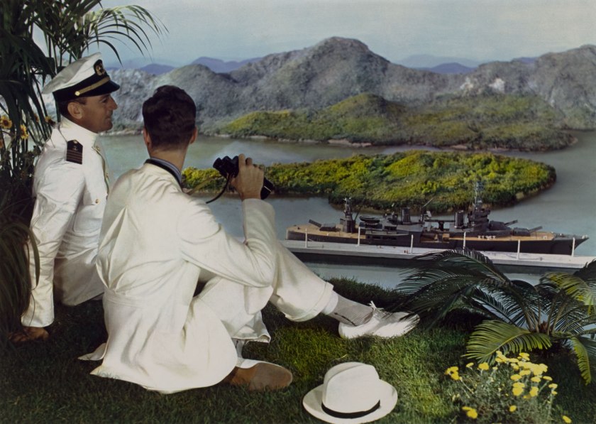 Lejaren à Hiller (American, 1880-1969) 'Men posed in front of backdrop with ship' c. 1950