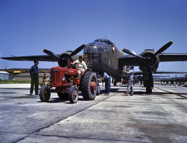 Alfred Palmer. 'B-25 bomber plane at North American Aviation being hauled along an outdoor assembly line. Kansas City, Kansas.' October 1942
