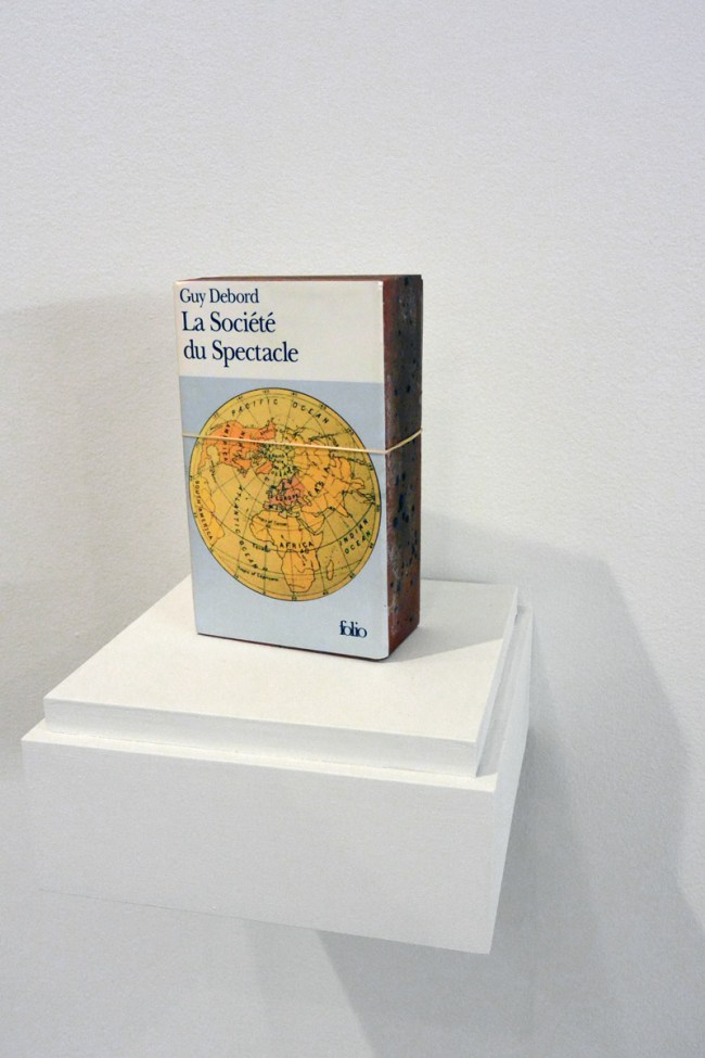 Claire Fontaine (Italian, b. 1975) 'La société du spectacle brickbat' 2006 (installation view)