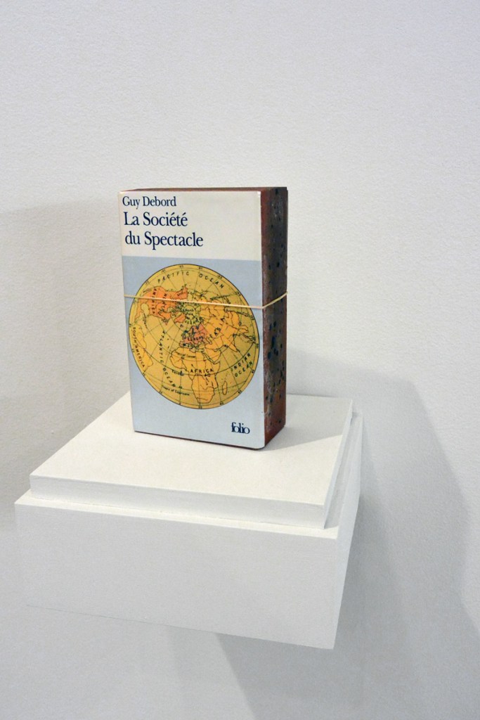 Claire Fontaine (Italian, b. 1975) 'La société du spectacle brickbat' 2006 (installation view) Claire Fontaine (Italian, b. 1975) 'La société du spectacle brickbat' 2006 (installation view)