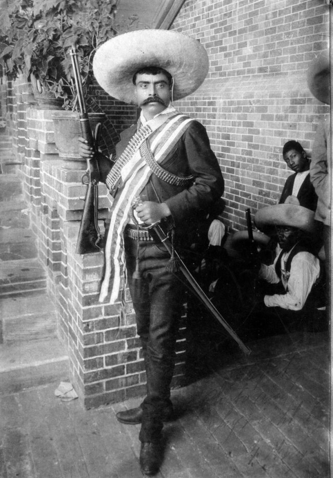 Hugo Brehme (?) (German, 1882-1954, active in Mexico) 'Emiliano Zapata with Rifle, Sash, and Saber, Cuernavaca' June 1911 Hugo Brehme (?) (German, 1882-1954, active in Mexico) 'Emiliano Zapata with Rifle, Sash, and Saber, Cuernavaca' June 1911