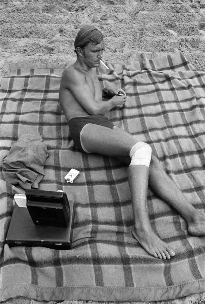 Enrico Natali. 'Man with injured knee at the beach smoking, Detroit, 1968' 1968