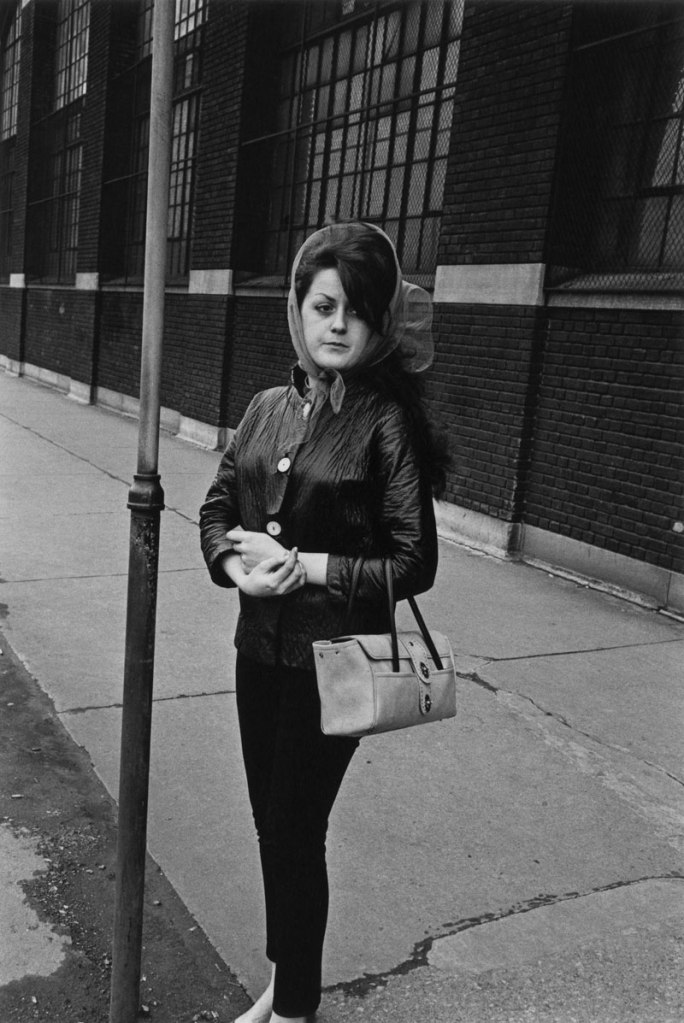 Enrico Natali. 'Woman outside a tire factory waiting for the bus, Detroit, 1968' 1968