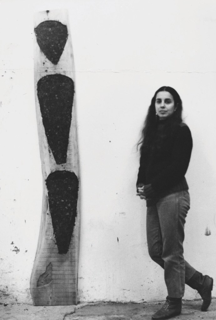 Ana Mendieta with 'Untitled' wood sculpture, 1984-1985 Ana Mendieta with 'Untitled' wood sculpture, 1984-1985