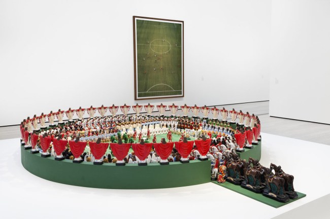 In the background: Andreas Gursky (German, b. 1955) 'Maracana' 2003 and Andreas Gursky 'Amsterdam, EM Arena I' 2000. In the foreground: Nelson Leirner (Brazil, 1932-2020) 'Maracana' 2003 (installation view)