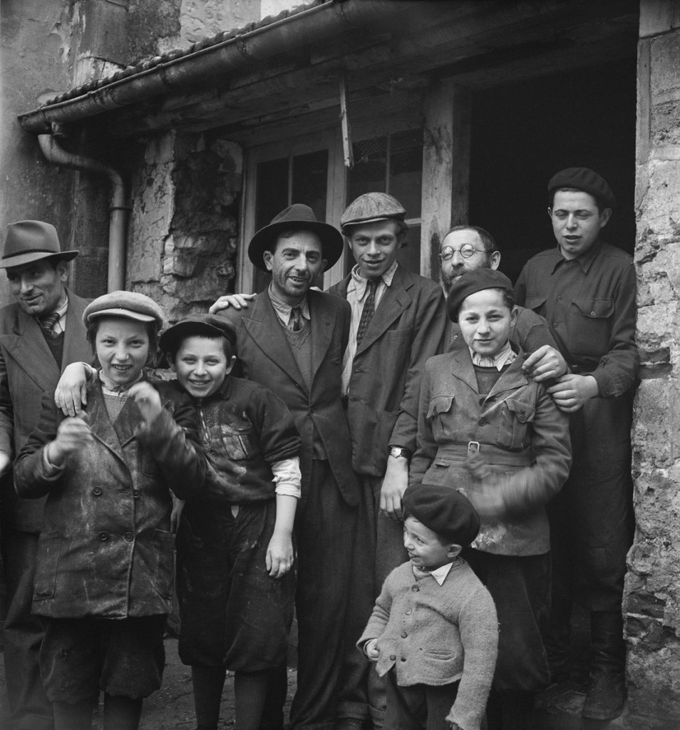 Roman Vishniac (Russian-American, 1897-1990) '[Holocaust survivors gathering outside a building where matzoh is being made in preparation for the Passover holiday, Hénonville Displaced Persons' Camp, Picardy, France]' 1947