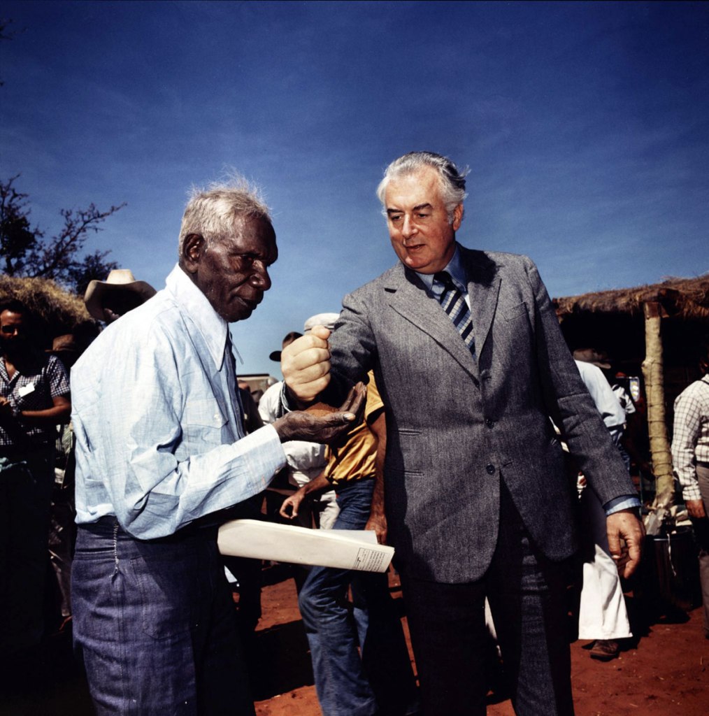 Mervyn Bishop (Australian, b. 1945) 'Prime Minister Gough Whitlam pours soil into the hands of traditional land owner Vincent Lingiari, Northern Territory' 1975
