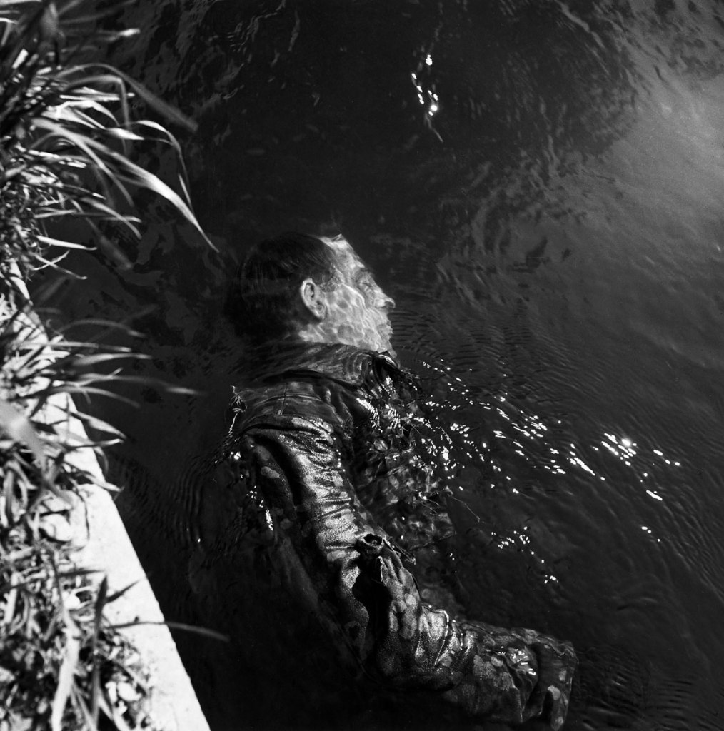 Lee Miller (American, 1907-1977) 'Dead SS Prison Guard Floating in Canal, Dachau, Germany' 1945