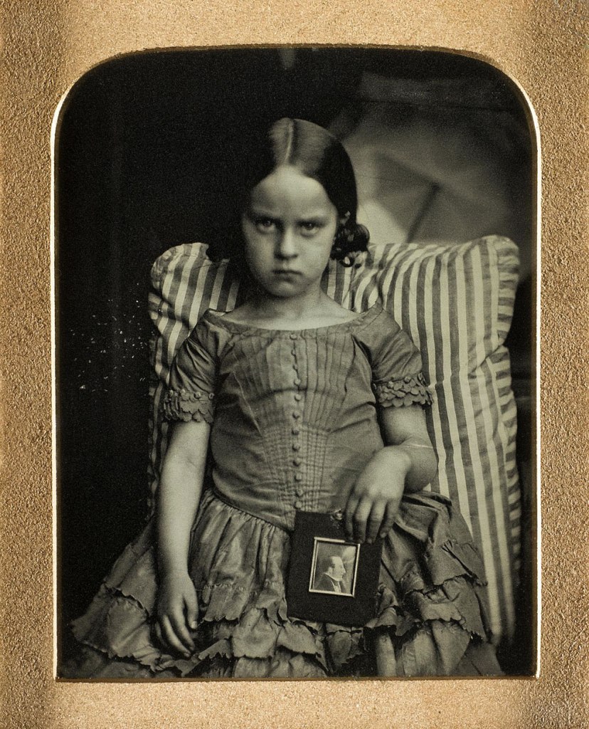 Ross and Thomson of Edinburgh. 'Unknown little girl sitting on a striped cushion holding a framed portrait of a man, possibly her dead father' 1847-1860