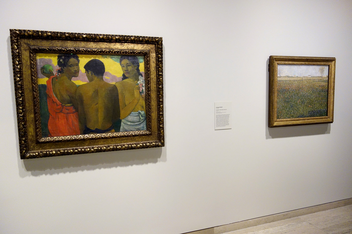 Installation view of the exhibition 'The Greats: Masterpieces from the National Galleries of Scotland' at the Art Gallery of New South Wales, Sydney showing at left Paul Gauguin's 'Three Tahitians' (1899) and at right, Georges Seurat's 'La luzerne, Saint-Denis' (1884-1885) Installation view of the exhibition 'The Greats: Masterpieces from the National Galleries of Scotland' at the Art Gallery of New South Wales, Sydney showing at left Paul Gauguin's 'Three Tahitians' (1899) and at right, Georges Seurat's 'La luzerne, Saint-Denis' (1884-1885)