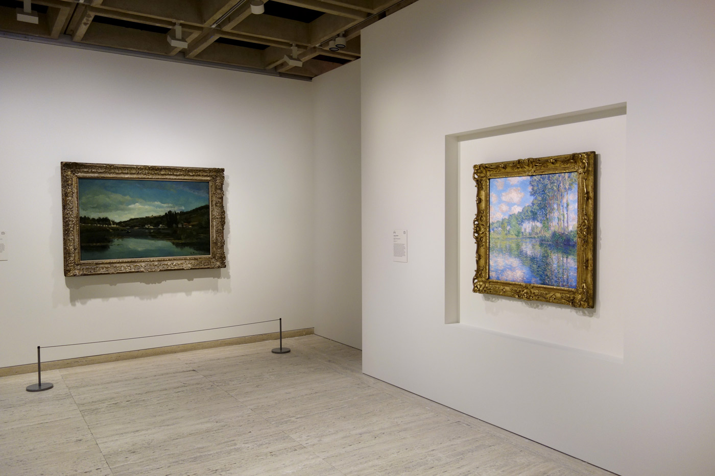 Installation view of the exhibition 'The Greats: Masterpieces from the National Galleries of Scotland' at the Art Gallery of New South Wales, Sydney showing at left, Camille Pissarro's 'The Marne at Chennevières' (c. 1864-1865) and at right, Claude Monet's 'Poplars on the Epte' (1891) Installation view of the exhibition 'The Greats: Masterpieces from the National Galleries of Scotland' at the Art Gallery of New South Wales, Sydney showing at left, Camille Pissarro's 'The Marne at Chennevières' (c. 1864-1865) and at right, Claude Monet's 'Poplars on the Epte' (1891)
