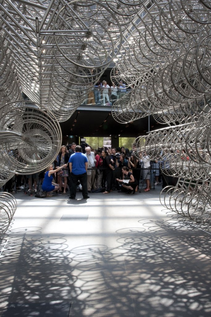 Ai Weiwei talking to the media in front of his installation 'Forever Bicycles' (2015) at the opening of the exhibition 'Andy Warhol | Ai Weiwei' at the National Gallery of Victoria, Melbourne Ai Weiwei talking to the media in front of his installation 'Forever Bicycles' (2015) at the opening of the exhibition 'Andy Warhol | Ai Weiwei' at the National Gallery of Victoria, Melbourne