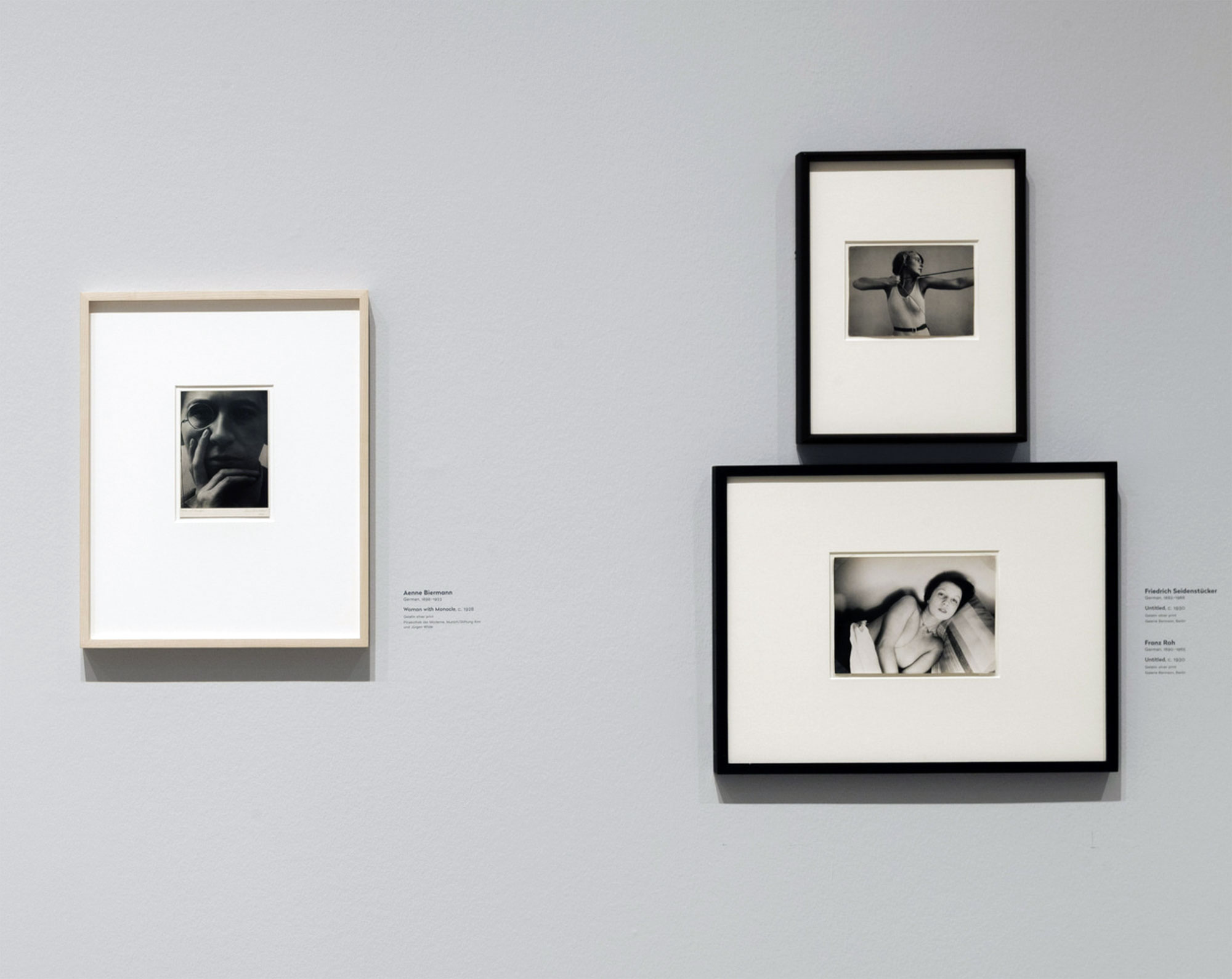 Installation view of the exhibition 'New Objectivity: Modern German Art in the Weimar Republic, 1919-1933' at LACMA showing Aenne Biermann, 'Woman with Monocle' (Dame mit Monokel), c. 1928 at left, with photographs by Friedrich Seidenstücker (right top) and Franz Roh (right bottom) Installation view of the exhibition 'New Objectivity: Modern German Art in the Weimar Republic, 1919-1933' at LACMA showing Aenne Biermann, 'Woman with Monocle' (Dame mit Monokel), c. 1928 at left, with photographs by Friedrich Seidenstücker (right top) and Franz Roh (right bottom)