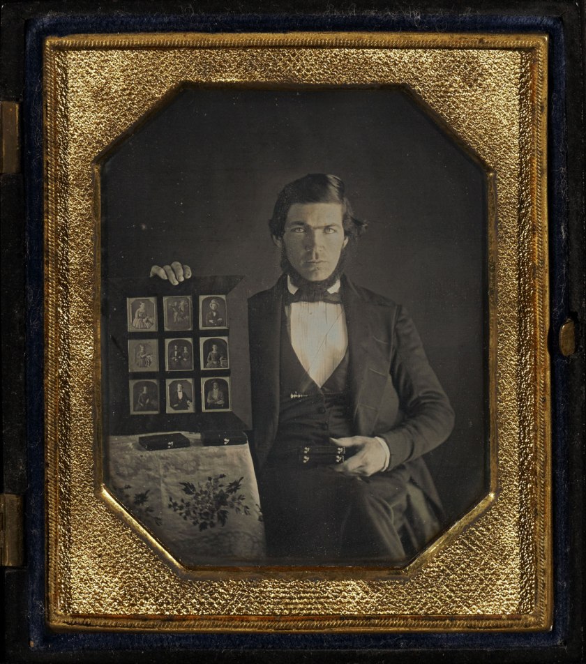 Unknown maker (American) '[Portrait of an Unidentified Daguerreotypist Displaying a Selection of Daguerreotypes] / Daguerreotypist (?) Displaying Thirteen Daguerreotypes' 1845