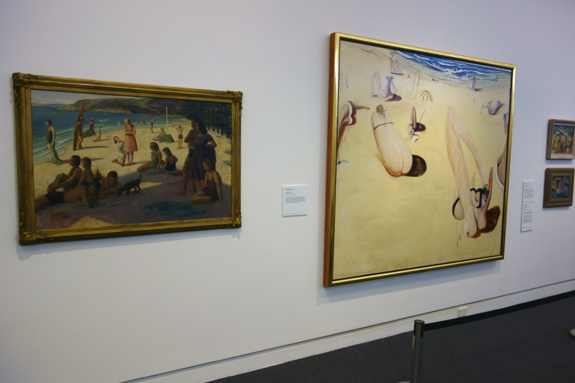 Installation view of the exhibition 'On the beach' at the Mornington Peninsula Regional Art Gallery showing in the centre, Brett Whiteley's 'Balmoral' (1975-1978). To the left of this painting is Nancy Kilgour's 'Figures on Manly Beach' (1930) and to the right Norma Bull's 'Bathing Beach' (c. 1950-1960s) with at bottom, George W. Lambert's 'Anzacs bathing in the sea' (1915)