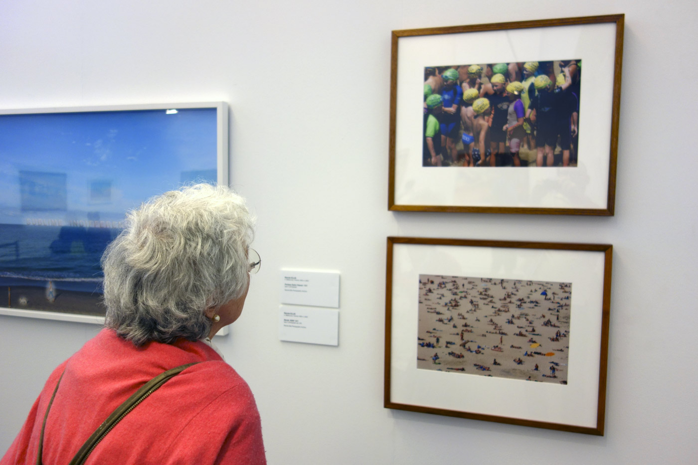 Photographer Joyce Evans looking at two colour photographs by Rennie Ellis in the exhibition 'On the beach' at the Mornington Peninsula Regional Art Gallery Photographer Joyce Evans looking at two colour photographs by Rennie Ellis in the exhibition 'On the beach' at the Mornington Peninsula Regional Art Gallery