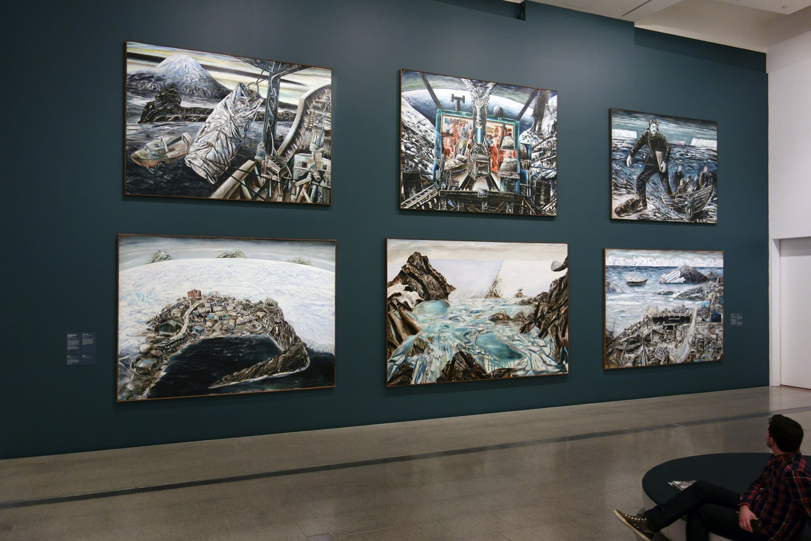 Installation view of the exhibition 'Jan Senbergs: Observation – Imagination' at The Ian Potter Centre: NGV Australia showing in the bottom image at top left, 'Bea Maddock being lifted onto the Icebird – Heard Island' (1987); at top middle, 'Antarctic night' (1989); at bottom left, 'Mawson'; and at bottom middle, 'Platcha' (1987)