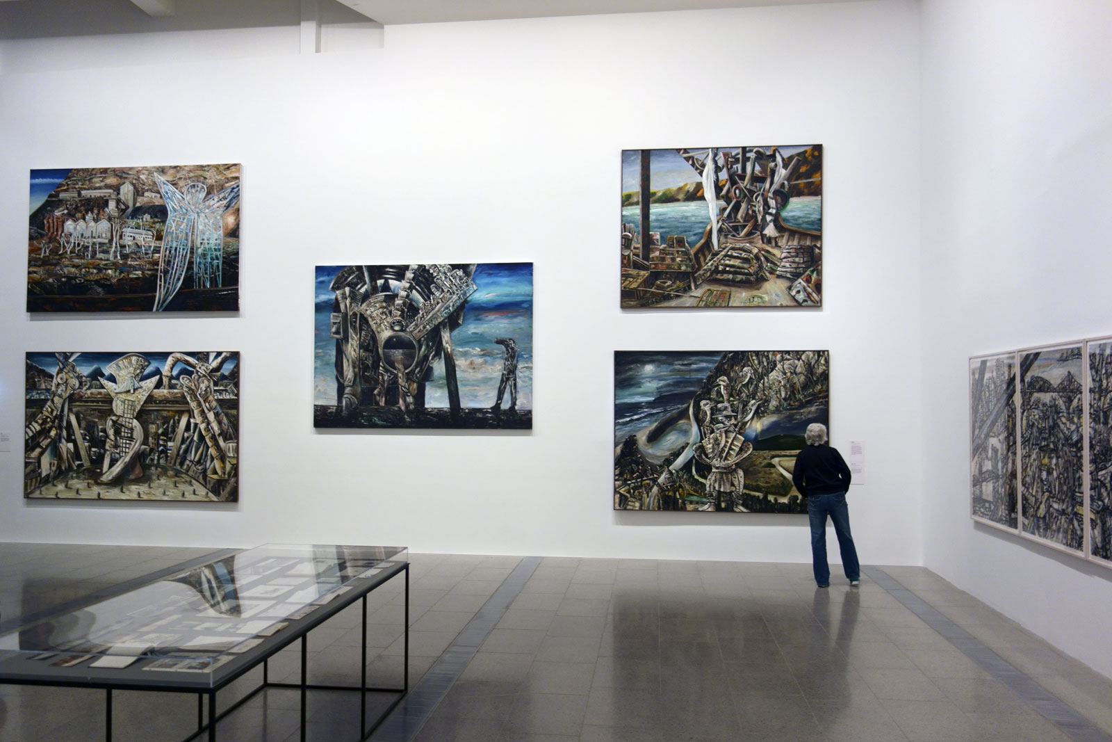 Installation view of the exhibition 'Jan Senbergs: Observation – Imagination' at The Ian Potter Centre: NGV Australia showing 'Blue angel of Wittenoom' at top left (1988, below); and 'Otway night' at bottom right (1994, below)