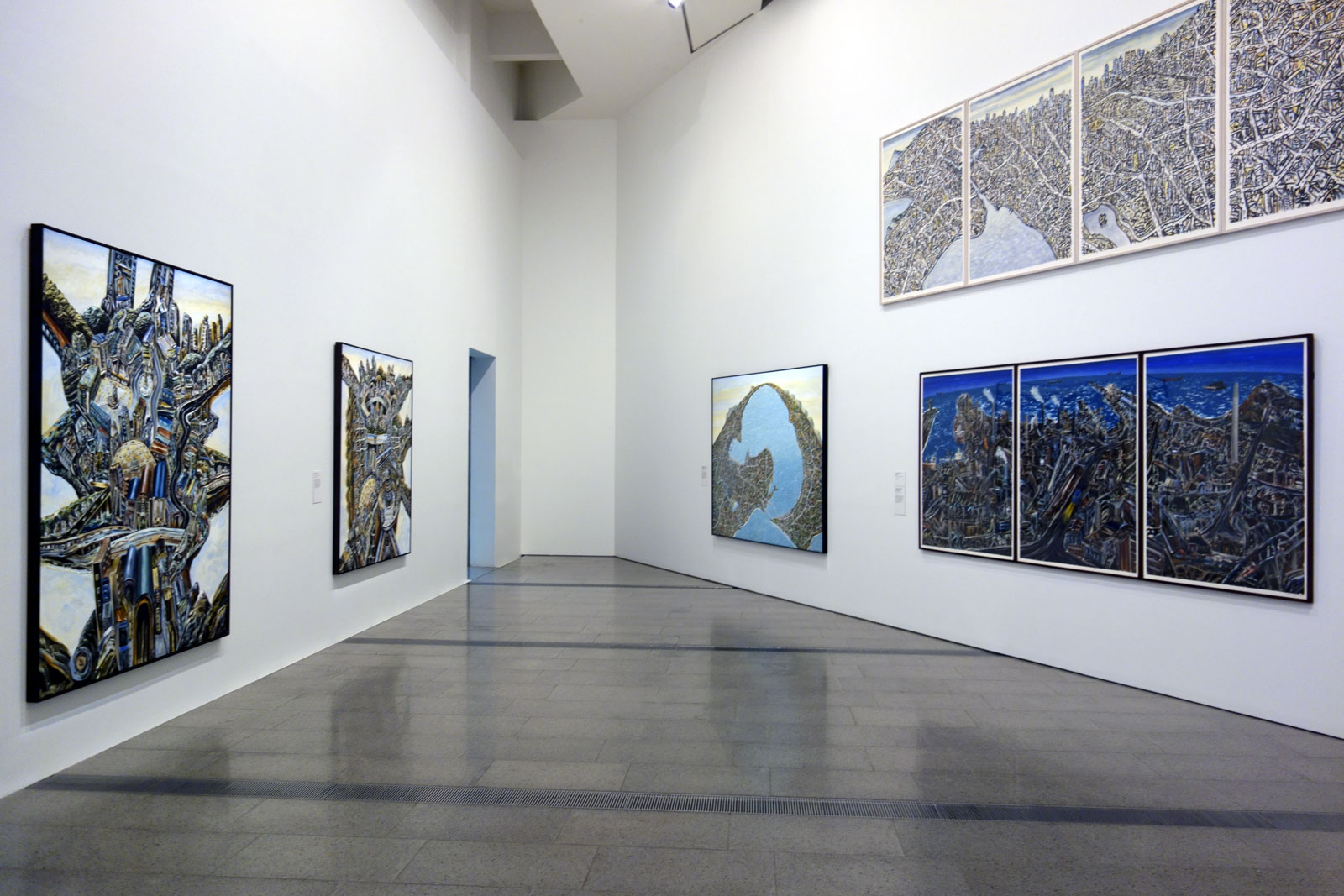 Installation view of the opening room of the exhibition 'Jan Senbergs: Observation – Imagination' at The Ian Potter Centre: NGV Australia showing at left in both images, 'The elated city' followed by 'Paolozzi's city'