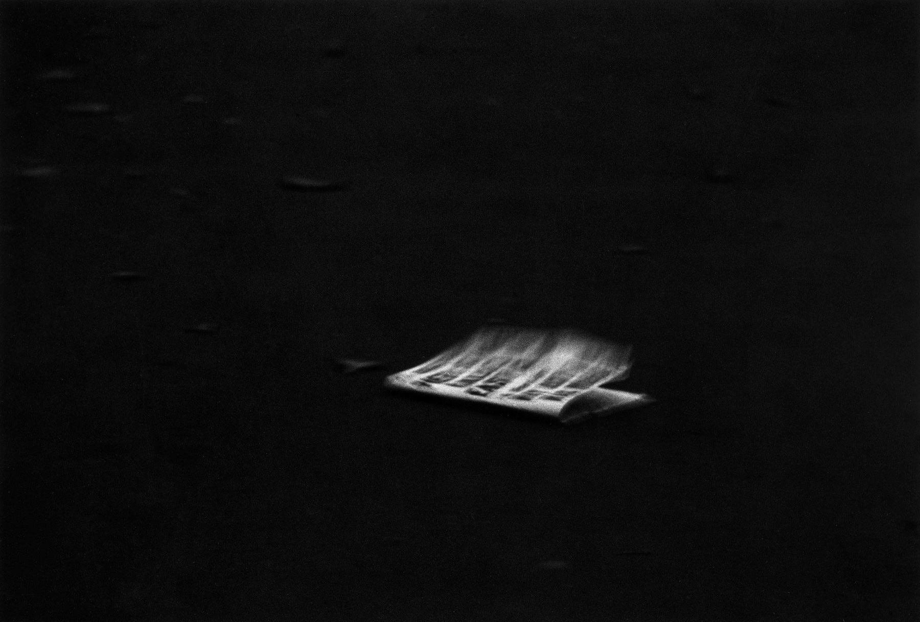 Diane Arbus (American, 1923-1971) 'Windblown headline on a dark pavement, N.Y.C., 1956' 1956