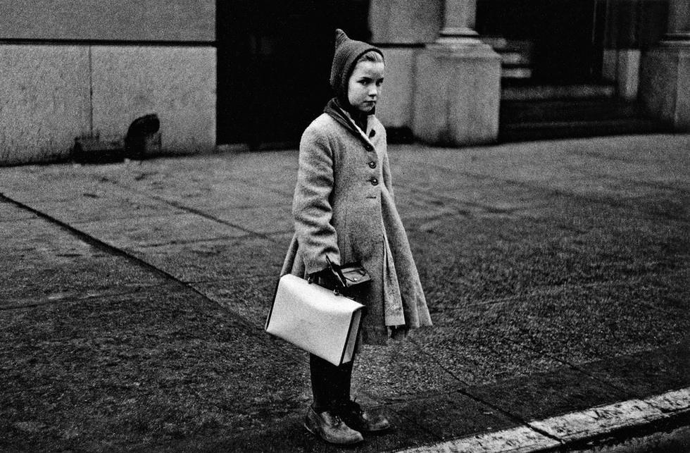 Diane Arbus (American, 1923-1971) 'Girl with a pointy hood and white schoolbag at the curb, N.Y.C. 1957' 1957