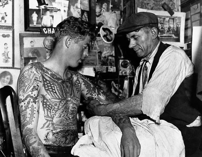 Unknown photographer. 'Untitled [Charlie Wagner tattooing in his studio]' Nd