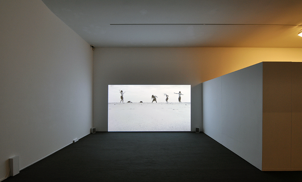Installation view of the exhibition 'Under the sun Reimagining Max Dupain's 'Sunbaker'' at Monash Gallery of Art, Melbourne showing Nasim Nasr's 'Still for Eighty Years' (2017)
