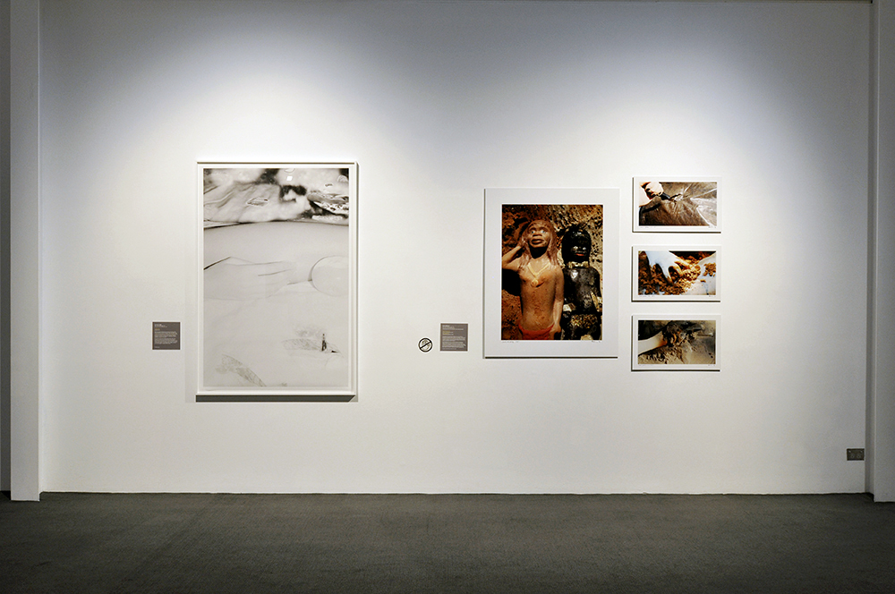 Installation view of the exhibition 'Under the sun Reimagining Max Dupain's 'Sunbaker'' at Monash Gallery of Art, Melbourne showing Destiny Deacon's 'Sand minding and Sand grabs' (2017)
