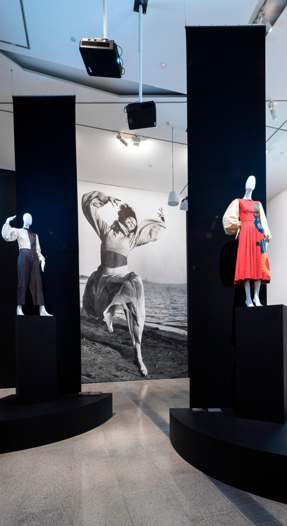 Installation views of the exhibition 'Brave New World: Australia 1930s' at NGVA featuring a wall print of 'Sonia Revid dancing on Brighton beach' c. 1935 by an unknown Australian photographer