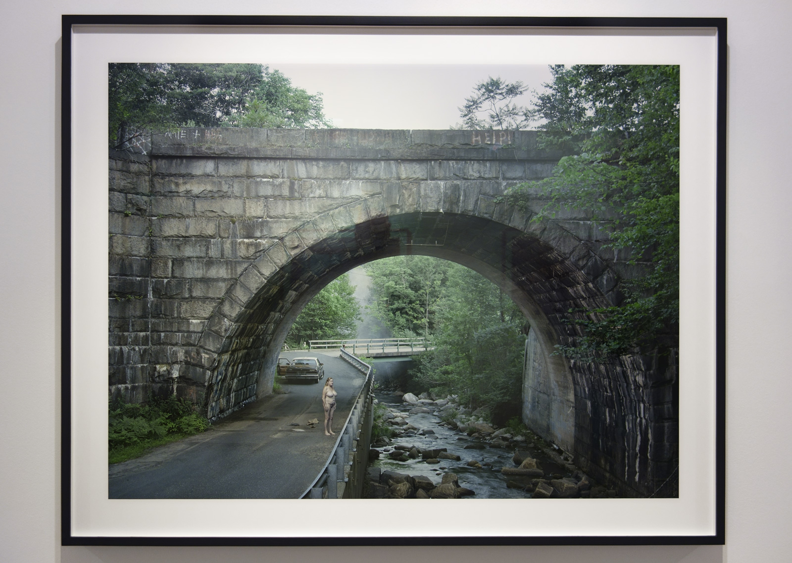 Installation view of Room 3 of 'Gregory Crewdson: Cathedral of the Pines' at The Photographers' Gallery showing 'Woman on Road' 2014