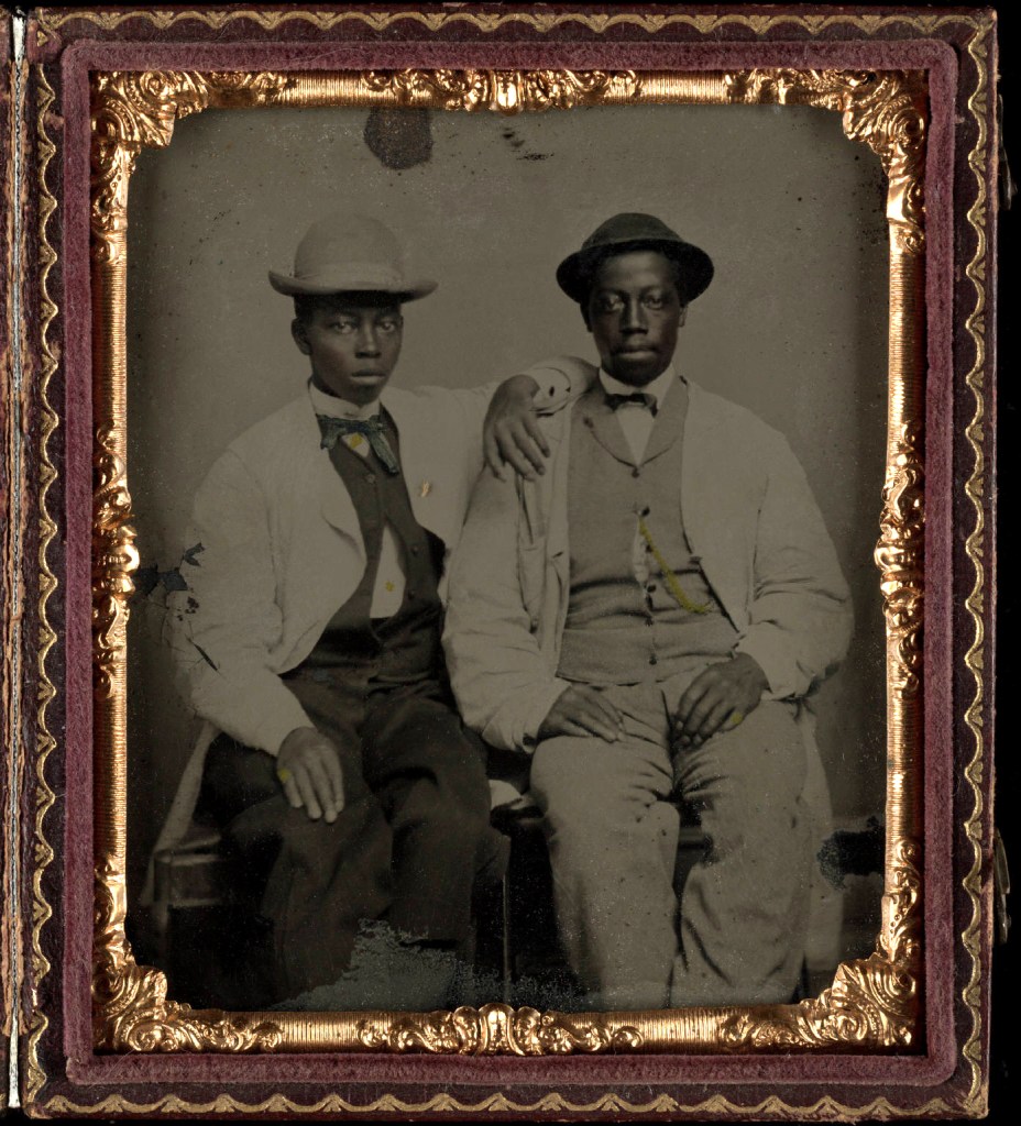 Unknown photographer (American) 'Untitled [Two young men with straw hats, seated beside each other]' Nd