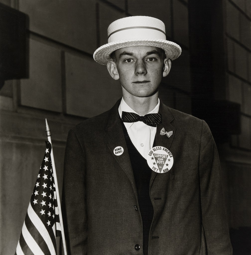 Diane Arbus (American, 1923-1971) 'Boy with a straw hat waiting to march in a pro-war parade, N.Y.C., 1967' 1967