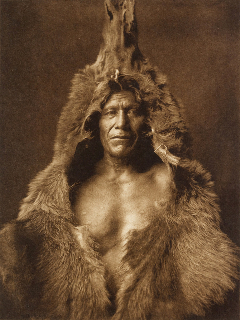 Edward S. Curtis (American, 1868-1952) '[Bear's Belly, Arikara Indian half-length portrait, facing front, wearing bearskin]' c. 1908 from 'Edward S. Curtis (1868-1952) – The North American Indian' List of Large Plates Supplementing Volume V