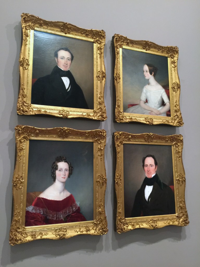 Installation view of the exhibition 'Colony: Australia 1770 - 1861' at NGV Australia at Federation Square, Melbourne showing Thomas Bock's paintings 'John Robertson' 1850 (top left); 'Mrs William Robertson' mid 1830s (bottom left); 'Jessie Robertson' 1850 (top right); and 'Captain William Robertson' 1830s (bottom right)