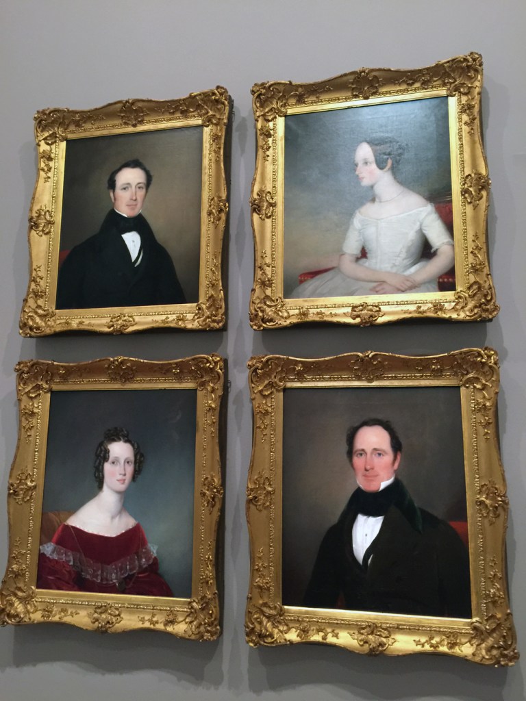 Installation view of the exhibition 'Colony: Australia 1770 - 1861' at NGV Australia at Federation Square, Melbourne showing Thomas Bock's paintings 'John Robertson' 1850 (top left); 'Mrs William Robertson' mid 1830s (bottom left); 'Jessie Robertson' 1850 (top right); and 'Captain William Robertson' 1830s (bottom right)